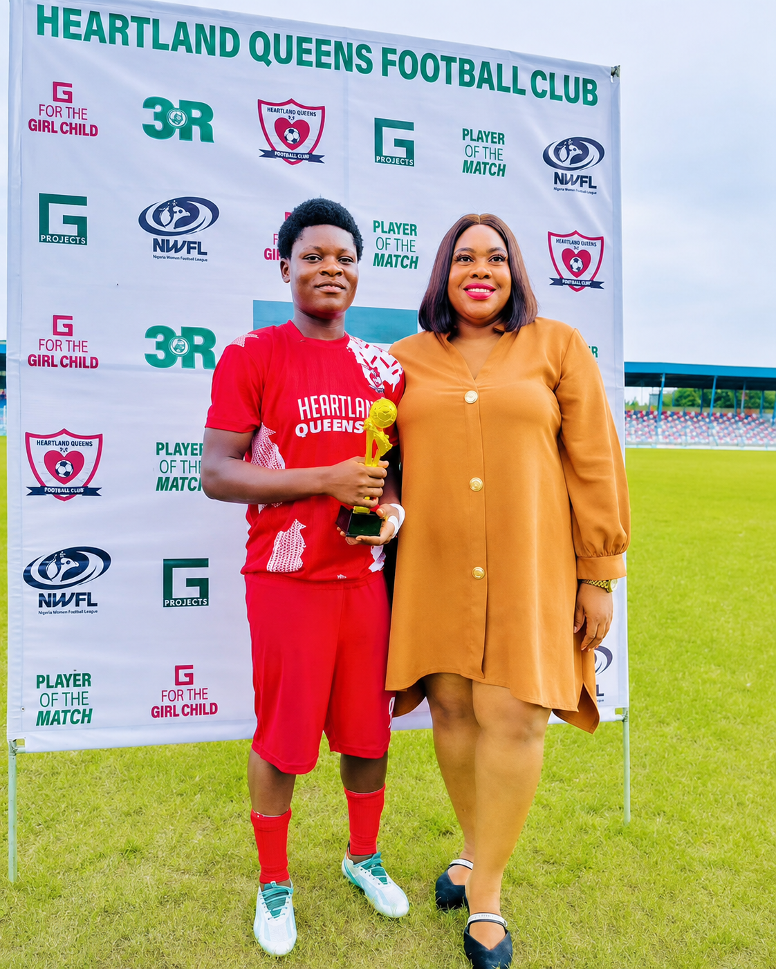 Women football player receiving player of the match recognition