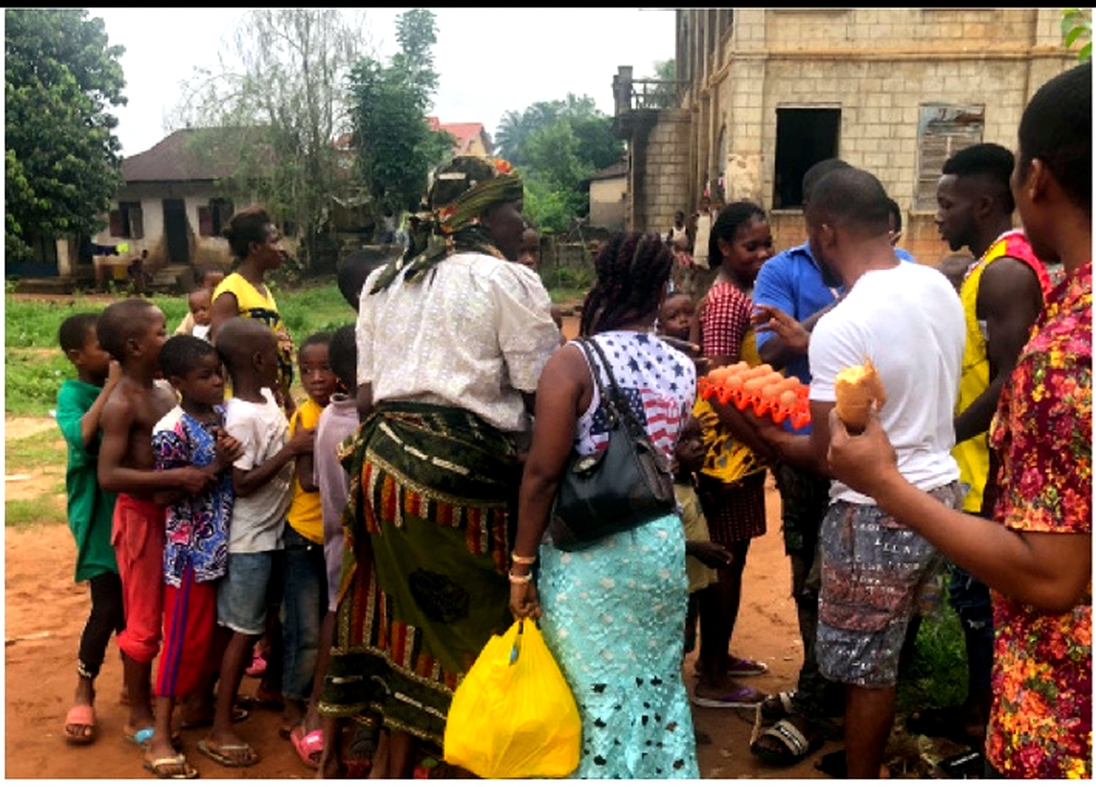 Children and community members receiving eggs during COVID-19 response