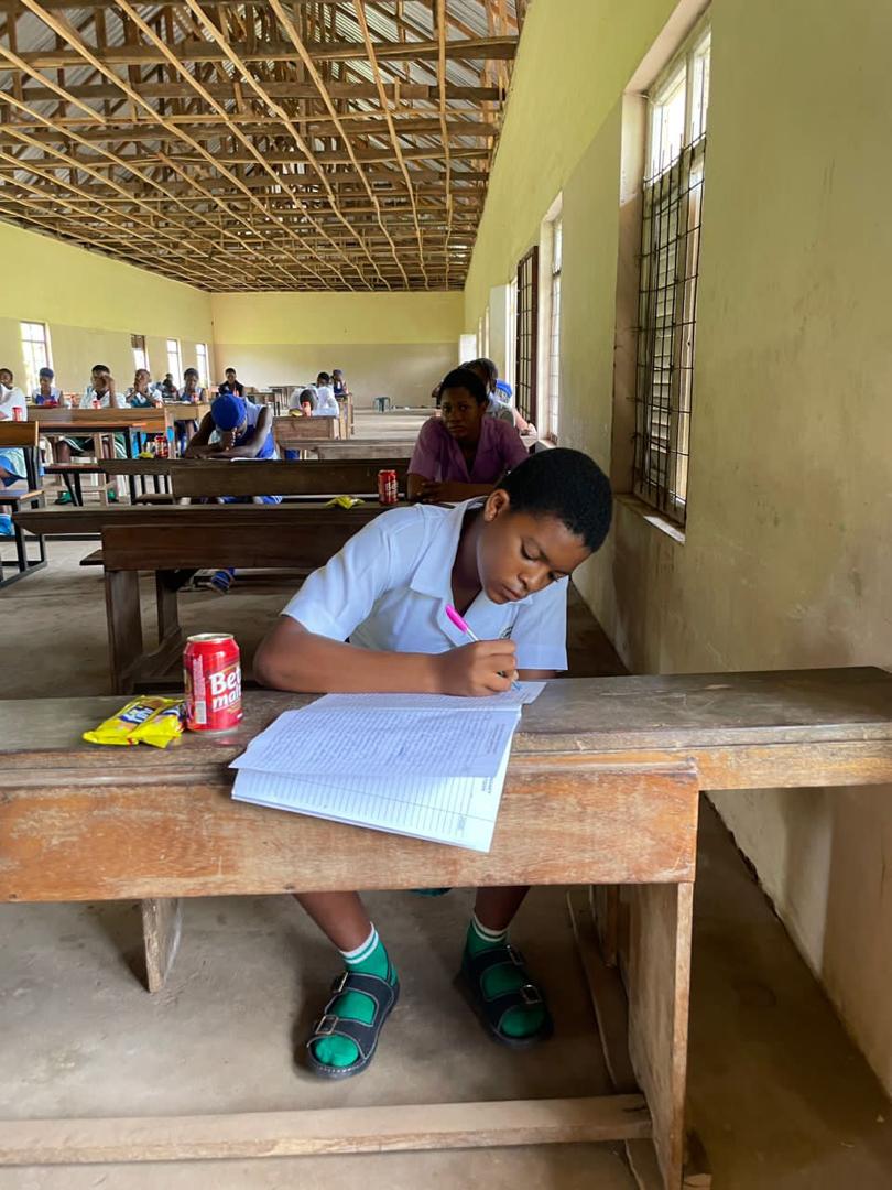 Student writing during the Ikeduru Essay Competition